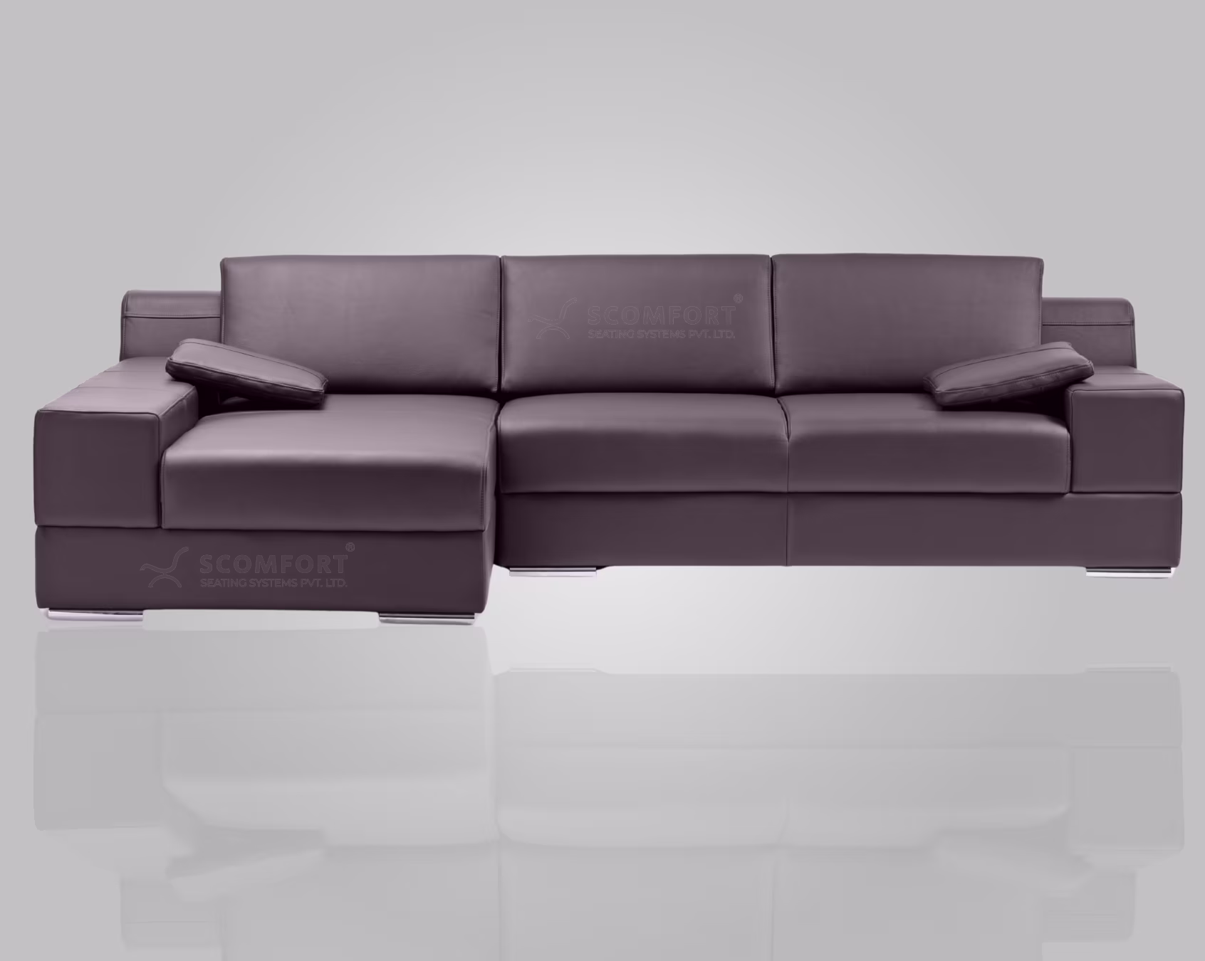 Modern gray leather sofa with chaise lounge and cushions in a minimalist living room