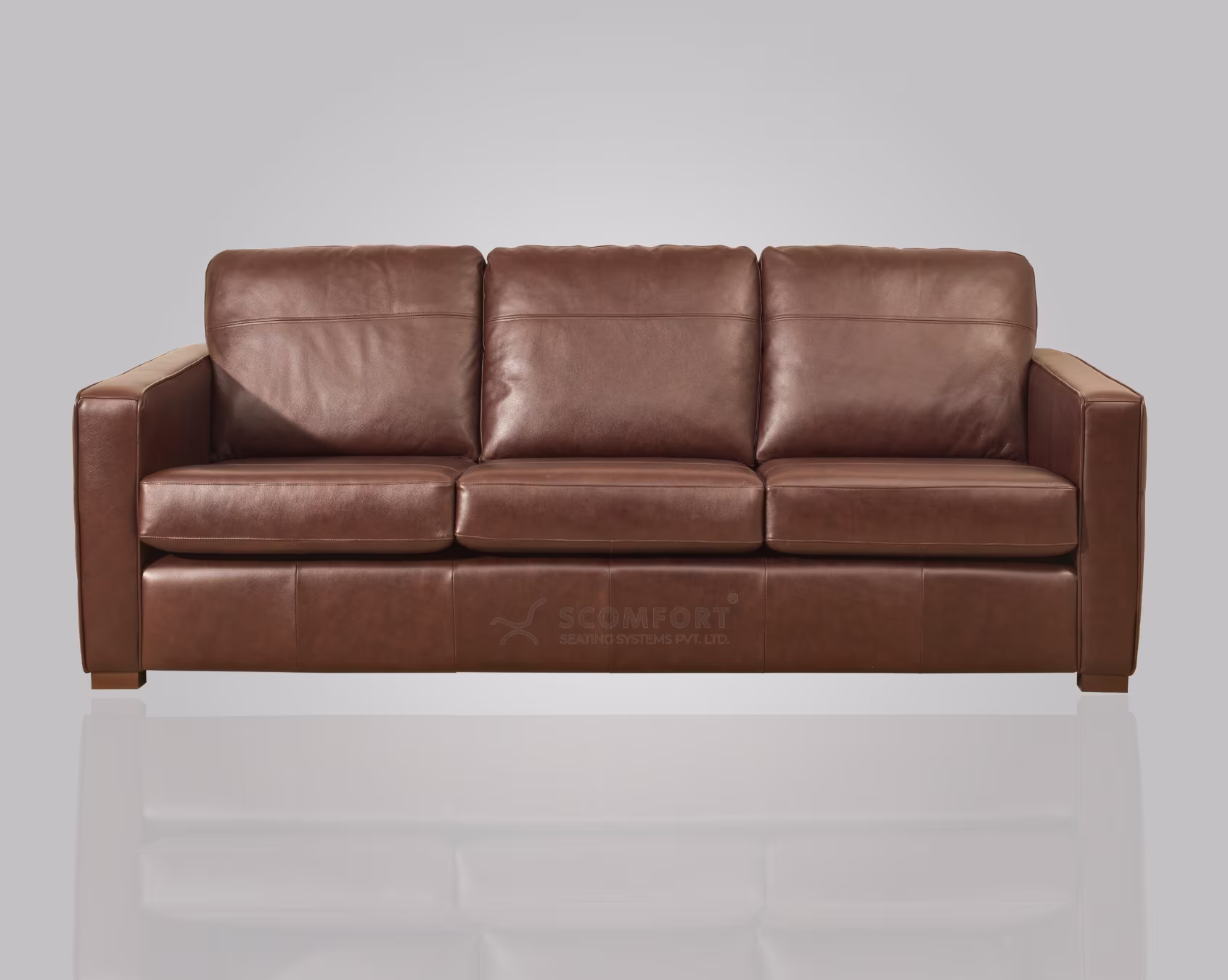 Brown leather three-seater sofa on a light background