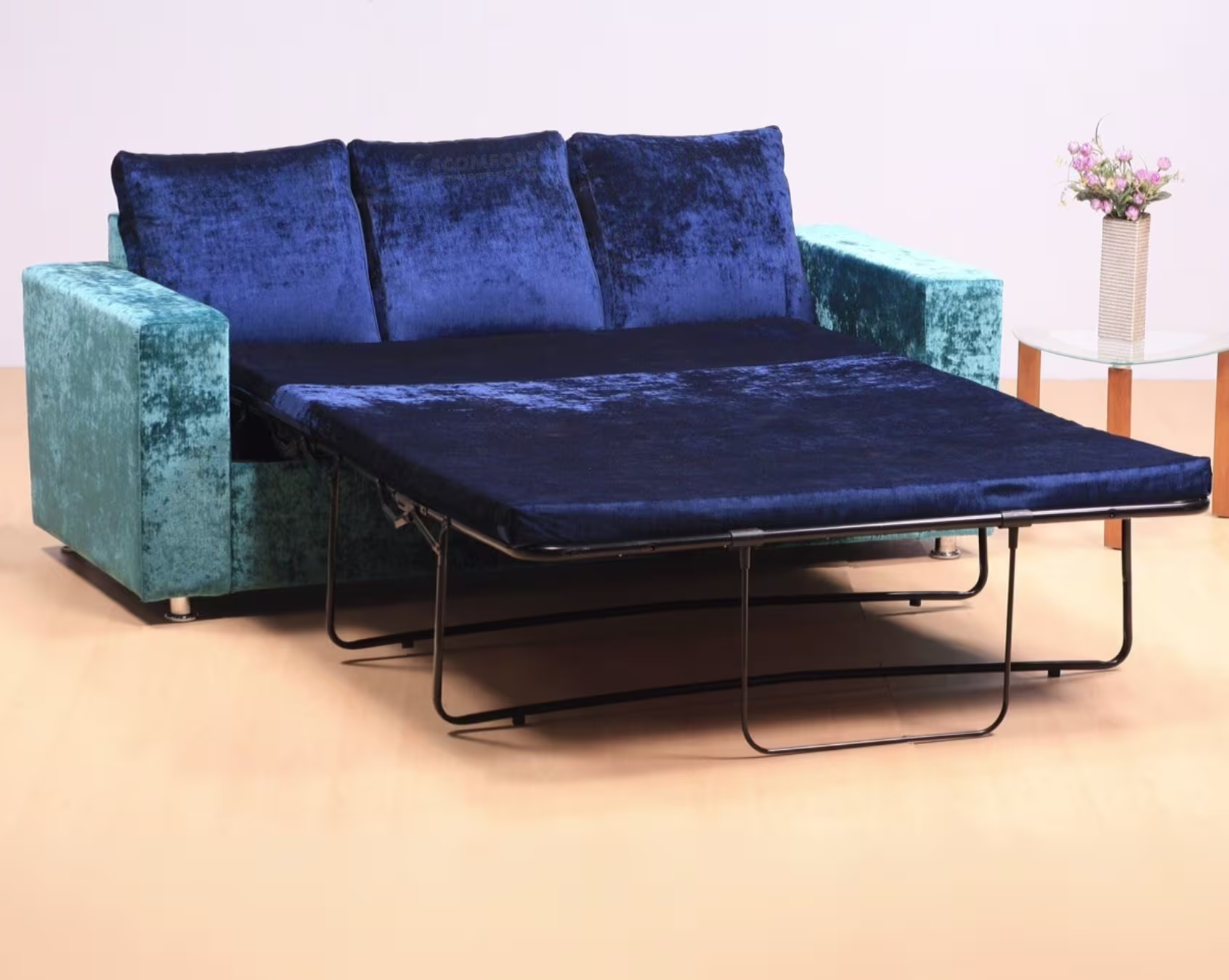 Modern blue velvet sofa with extendable pull-out bed and metal frame