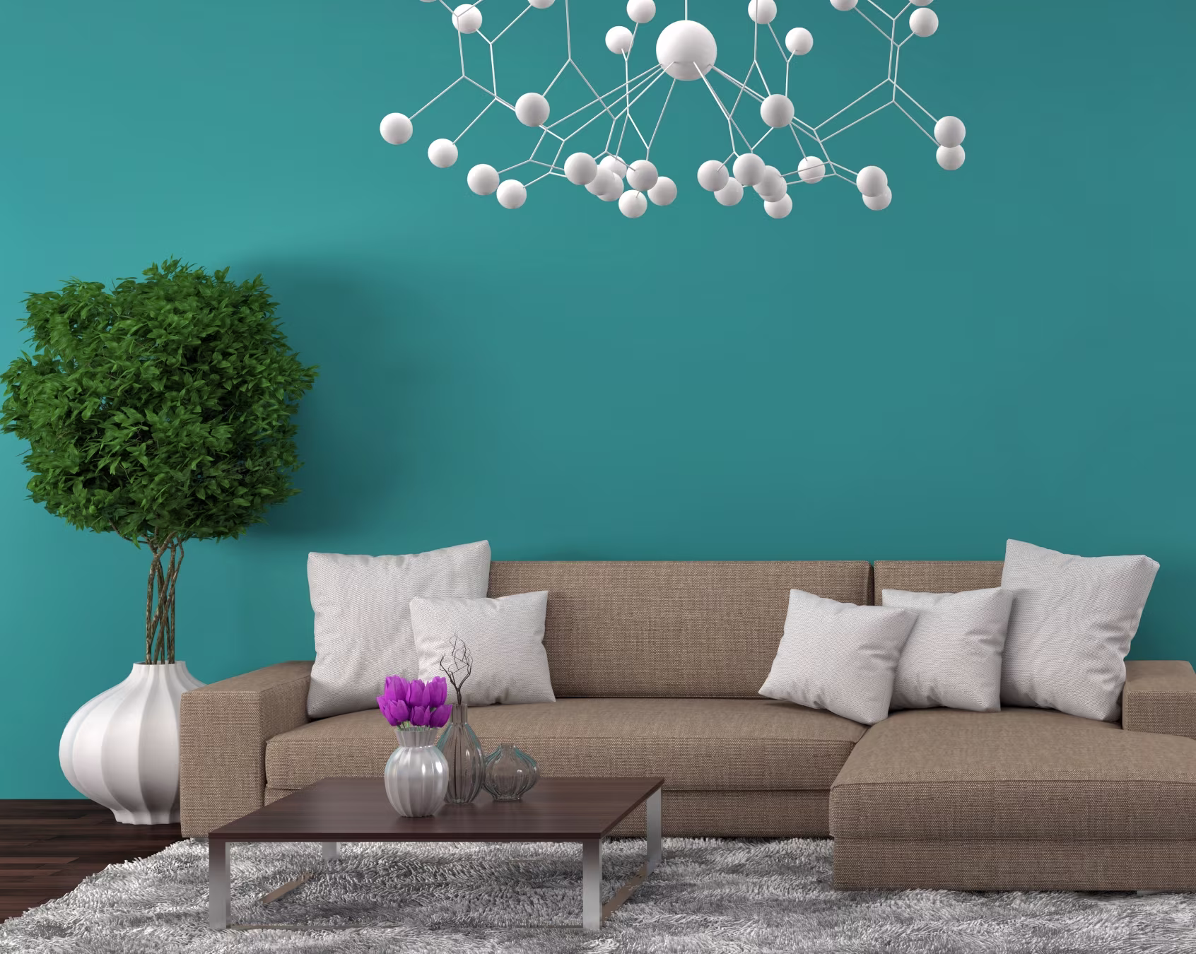 Modern beige sofa with white cushions in stylish living room with teal wall and decorative chandelier